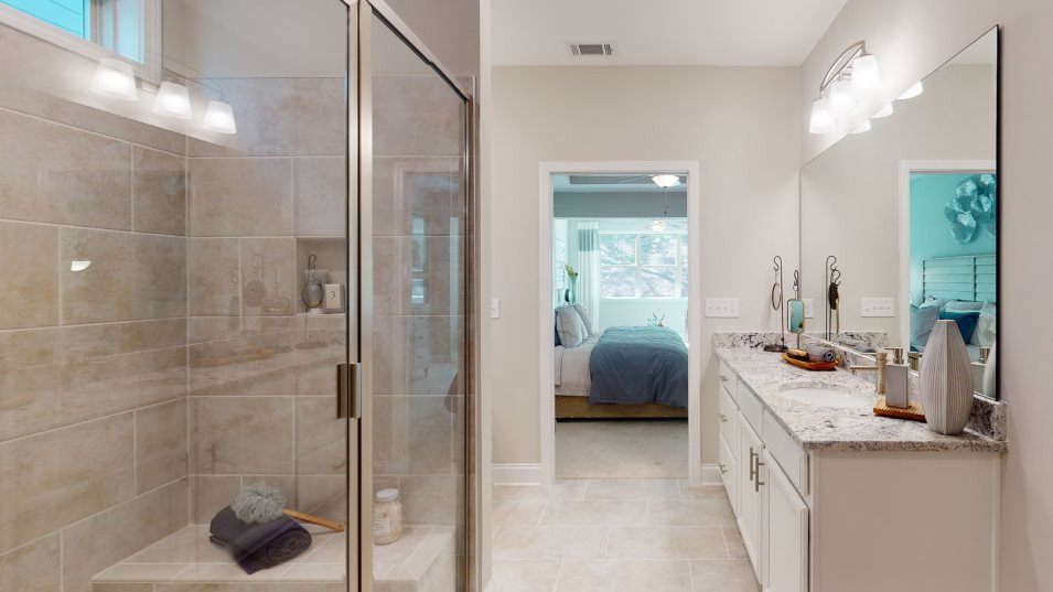 The glass-enclosed shower offers a luxurious exper