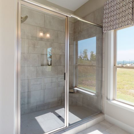 A generous glass-enclosed shower is well-equipped 